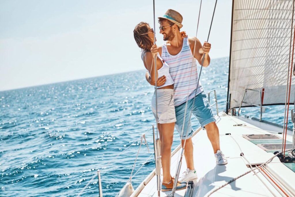 Blue ocean background. White sails. A facing and holding each other.